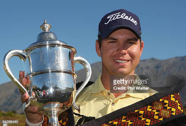Robert Gates of the USA poses with the winners trophy following day four of the New Zealand Open at The Hills Golf Club on January 31, 2010 in...