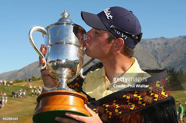 Robert Gates of the USA poses kisses the trophy following day four of the New Zealand Open at The Hills Golf Club on January 31, 2010 in Queenstown,...