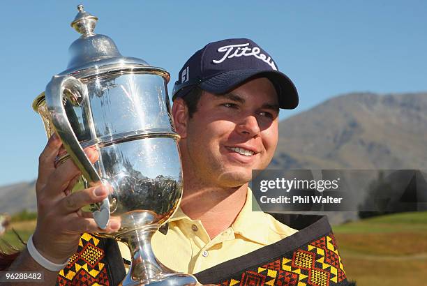 Robert Gates of the USA poses with the winners trophy following day four of the New Zealand Open at The Hills Golf Club on January 31, 2010 in...