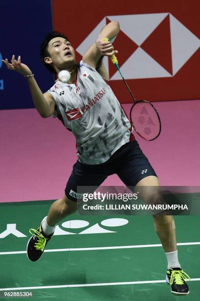 Japan's Kento Momota hits a return against China's Chen Long during their mens singles final match at the Thomas Cup badminton tournament in Bangkok...