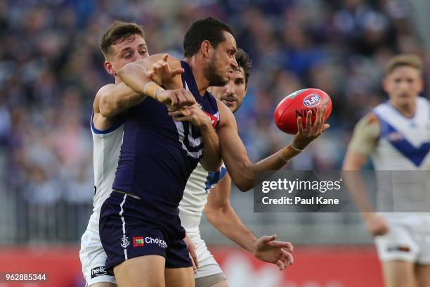 Michael Johnson of the Dockers gets tackled by Shaun Atley of the Kangaroos during the round 10 AFL match between the Fremantle Dockers and the North...