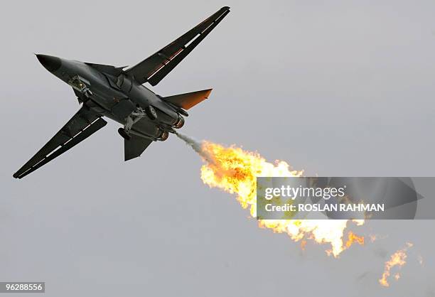 Royal Australian Air Force F-111 fighter jet releases a flame during a media preview of the Singapore Airshow in Singapore on January 31, 2010....