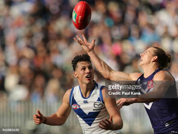 Ben Jacobs of the Kangaroos and Nathan Fyfe of the Dockers contest for the ball during the round 10 AFL match between the Fremantle Dockers and the...