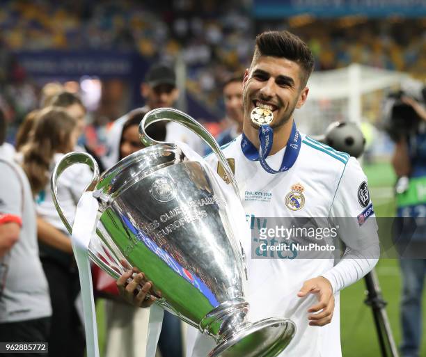 Marco Asensio of Real Madrid celebrates with the trophy after his side won the UEFA Champions League final between Real Madrid and Liverpool at NSC...