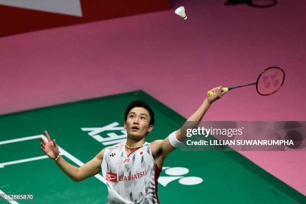 Japan's Kento Momota hits a return against China's Chen Long during their mens singles final match at the Thomas Cup badminton tournament in Bangkok...