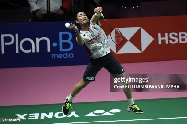 Japan's Kento Momota hits a return against China's Chen Long during their mens singles final match at the Thomas Cup badminton tournament in Bangkok...