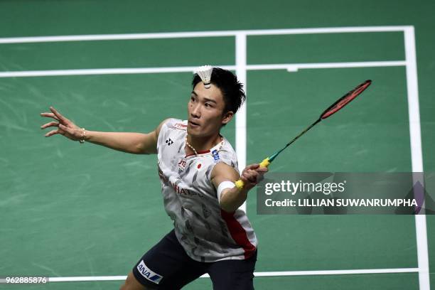 Japan's Kento Momota hits a return against China's Chen Long during their mens singles final match at the Thomas Cup badminton tournament in Bangkok...