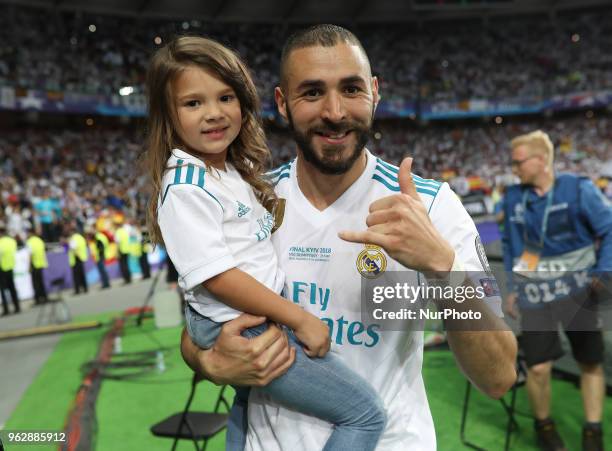 Karim Benzema of Real Madrid with his doughter celebrate winning the UEFA Champions League final between Real Madrid and Liverpool at NSC Olimpiyskiy...