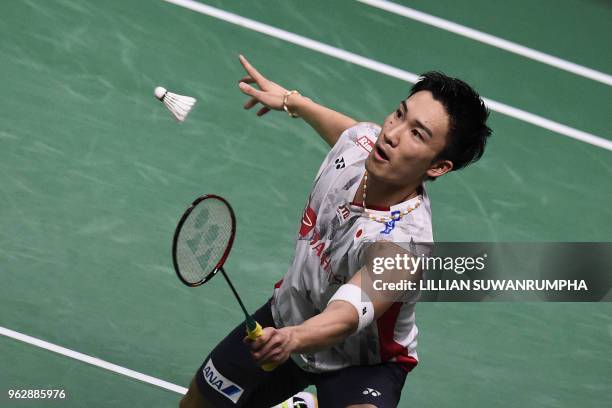 Japan's Kento Momota hits a return against China's Chen Long during their mens singles final match at the Thomas Cup badminton tournament in Bangkok...