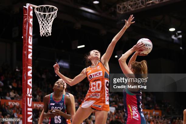 Tegan Philip of the Vixens shoots as Rebecca Bulley of the Giants defends during the round five Super Netball match between the Giants and the Vixens...