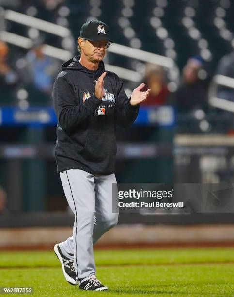 Manager Don Mattingly of the Miami Marlins walks out to the mound to make a pitching change in an MLB baseball game against the New York Mets on May...