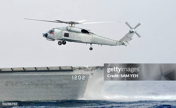 Taiwan-China-military-weapons" by Amber Wang A S-70C helicopter lands on the deck of a French made Lafayette class frigate during an annual drill...