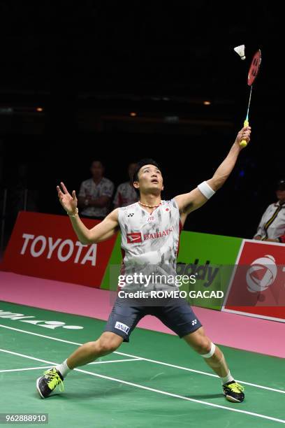 Japan's Kento Momota hits a return against China's Chen Long during their mens singles final match at the Thomas Cup badminton tournament in Bangkok...