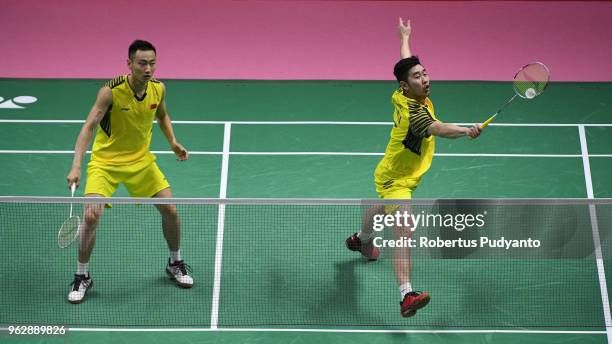 Liu Cheng and Zhang Nan of China compete against Takuto Inoue and Yuki Kaneko of Japan during the Thomas Cup Final match on day eight of the BWF...