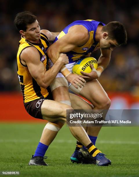 Elliot Yeo of the Eagles is tackled by Jaeger O'Meara of the Hawks during the 2018 AFL round 10 match between the Hawthorn Hawks and the West Coast...