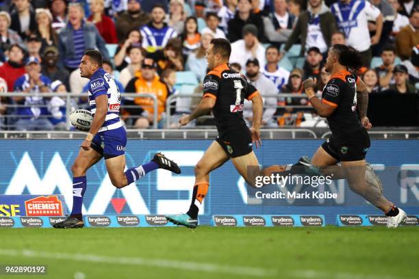 Marcelo Montoya of the Bulldogs makes a break during the round 12 NRL match between the Wests Tigers and the Canterbury Bulldogs at ANZ Stadium on...