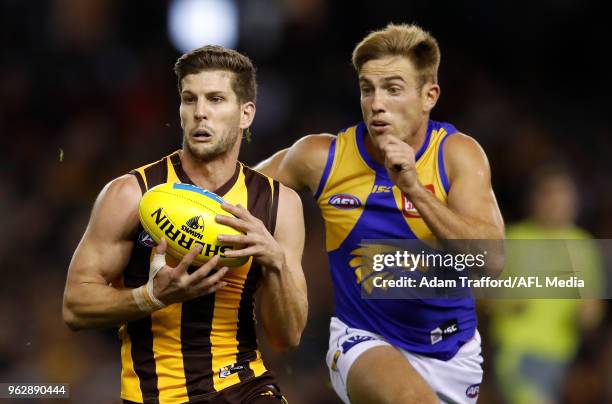 Luke Breust of the Hawks marks the ball ahead of Brad Sheppard of the Eagles during the 2018 AFL round 10 match between the Hawthorn Hawks and the...