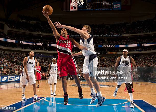 Andre Miller of the Portland Trail Blazers goes in for the layup against Dirk Nowitzki of the Dallas Mavericks during a game at the American Airlines...