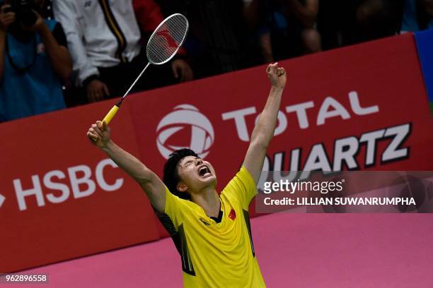 China's Shi Yuqi celebrates after defeating Japan's Kenta Nishimoto during their mens singles final match at the Thomas Cup badminton tournament in...