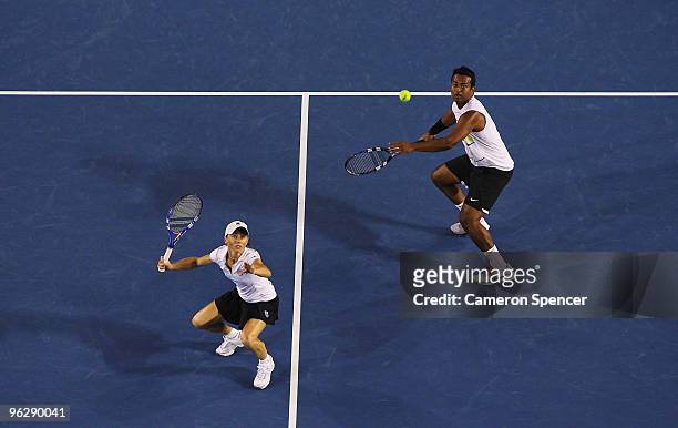 Cara Black of Zimbabwe and Leander Paes of India watch the tennis ball in their mixed doubles final match against Ekaterina Makarova of Russia and...