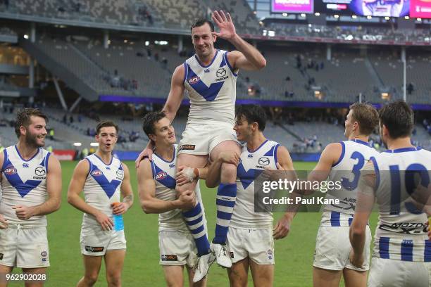 Todd Goldstein of the Kangaroos is chaired from the field after playing his 200th game during the round 10 AFL match between the Fremantle Dockers...