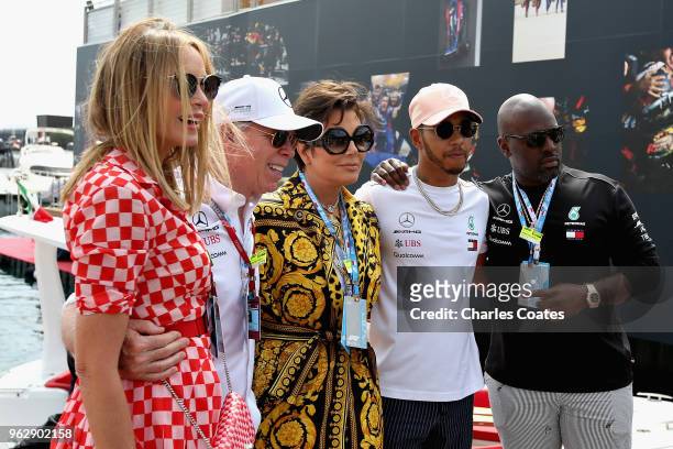 Lewis Hamilton of Great Britain and Mercedes GP poses for a photo with Dee Hilfiger, Tommy Hilfiger, Kris Jenner and Corey Gamble in the Paddock...
