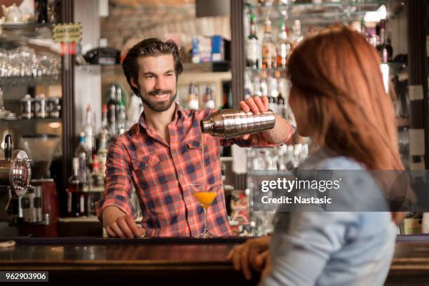 bartender serving cocktail to a costumer - costumer stock pictures, royalty-free photos & images