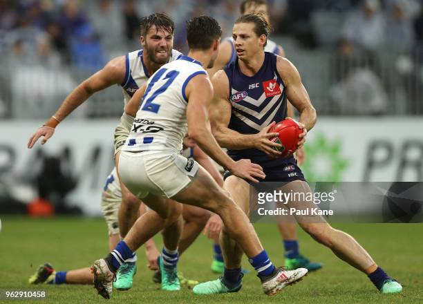 Nathan Fyfe of the Dockers looks to avoid being tackled during the round 10 AFL match between the Fremantle Dockers and the North Melbourne Kangaroos...