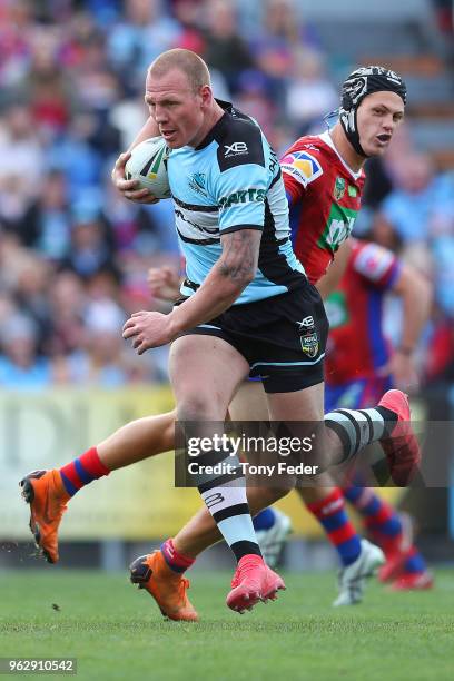 Luke Lewis of the Sharks runs in to score a try during the round 12 NRL match between the Newcastle Knights and the Cronulla Sharks at McDonald Jones...