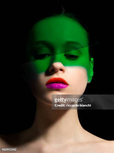 beautiful green and white woman with orange and fucsia lipstick - white lipstick stock-fotos und bilder