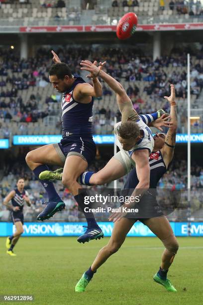 Michael Johnson and Michael Walters of the Dockers contest a mark against Jack Ziebell of the Kangaroos during the round 10 AFL match between the...