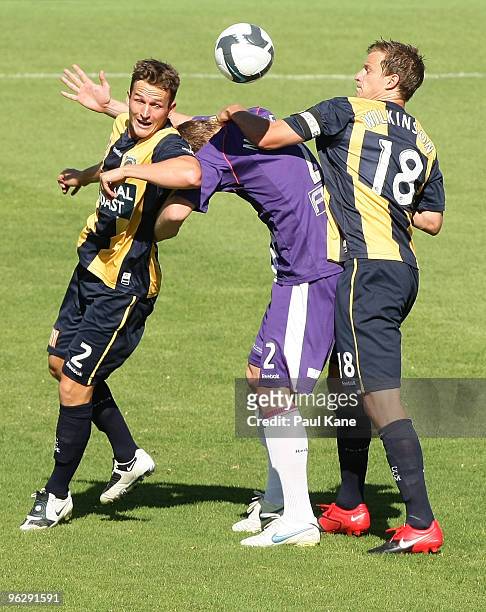 Daniel McBreen of the Glory is challenged by Matthew Crowell and Alex Wilkinson of the Mariners during the round 25 A-League match between the Perth...
