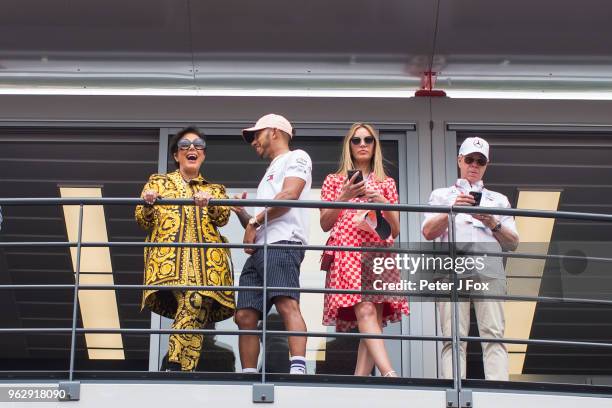 Lewis Hamilton of Mercedes and Great Britain chats with Kris Jenner as Dee Hilfiger and Tommy Hilfiger look on during the Monaco Formula One Grand...