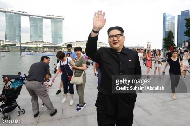 Kim Jong Un impersonator, Howard X, waves as he makes an appearance at Merlion Park on May 27, 2018 in Singapore. The proposed North Korea-United...