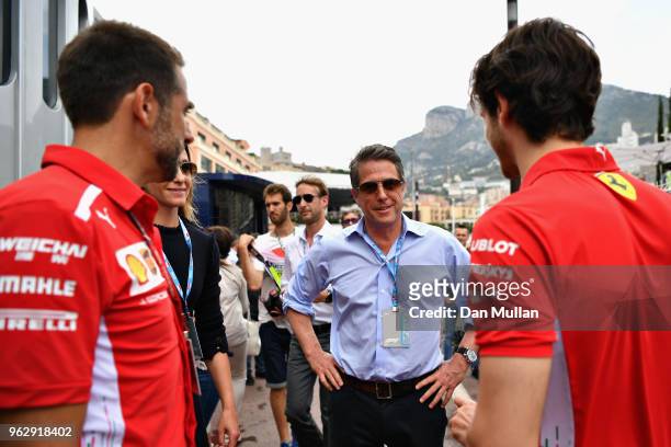 Actor Hugh Grant and his wife, TV producer Anna Eberstein talk with Antonio Giovinazzi of Italy and Ferrari in the Paddock before the Monaco Formula...