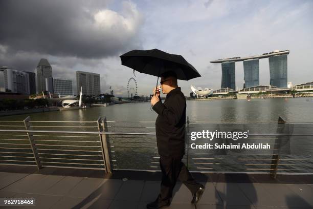 Kim Jong Un impersonator, Howard X, walks along the Jubilee Bridge as he makes an appearance at Marina Bay on May 27, 2018 in Singapore. The proposed...