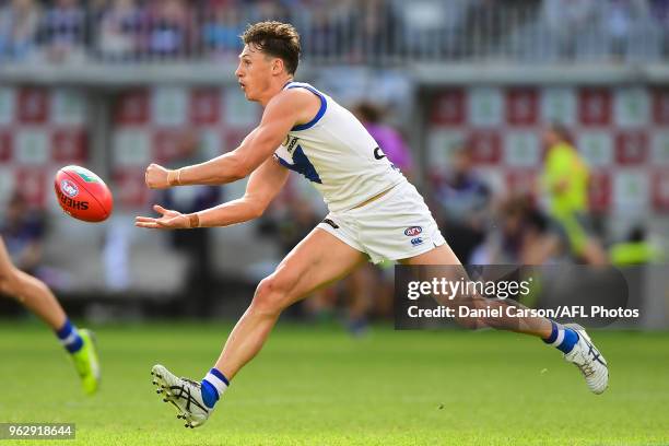 Ben Jacobs of the Kangaroos handpasses the ball during the 2018 AFL round 10 match between the Fremantle Dockers and the North Melbourne Kangaroos at...