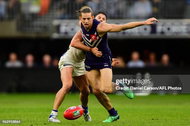 Nathan Fyfe of the Dockers is tackled off the ball during the 2018 AFL round 10 match between the Fremantle Dockers and the North Melbourne Kangaroos...