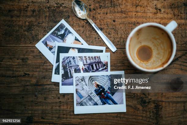 instant photos of woman on cafeteria table - stampare foto e immagini stock