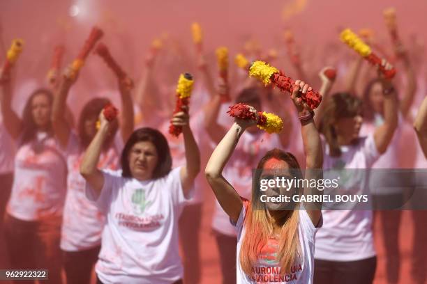 Anti-bullfighting protesters throw red flair representing bull´s blood during a demonstration as a part of the campaign "Bullfighting is Violence "...