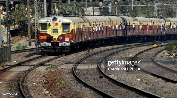 Local train approaches a station in Mumbai on January 30, 2010. AFP PHOTO/ Pal PILLAI