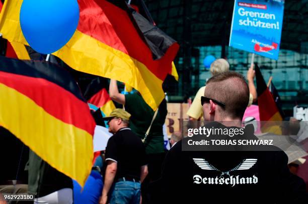 Alternative for Germany 's demonstrators holding AfD and German flags gather at the main station in Berlin to attend the "demonstration for the...
