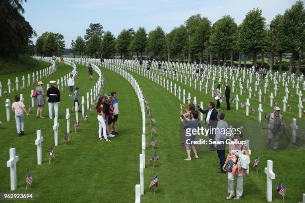 Visitors walk among the graves of U.S. Soldiers, most of them killed in the World War I Battle of Belleau Wood, following a ceremony to commemorate...