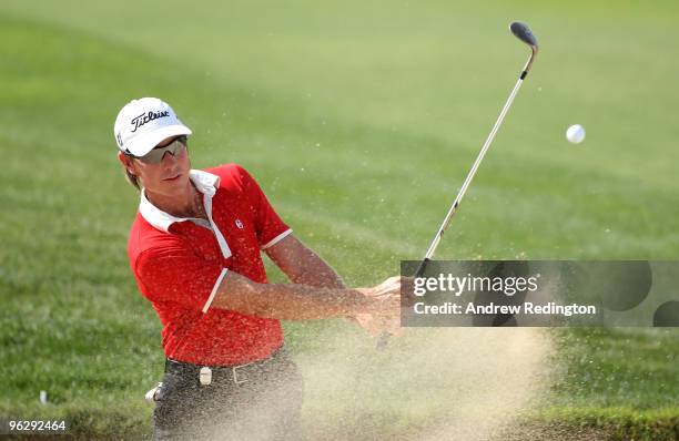 Brett Rumford of Australia plays a bunker shot on the sixth hole during the final round of the Commercialbank Qatar Masters at Doha Golf Club on...