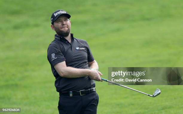 Branden Grace of South Africa plays his second shot on the par 4, first hole during the final round of the 2018 BMW PGA Championship on the West...