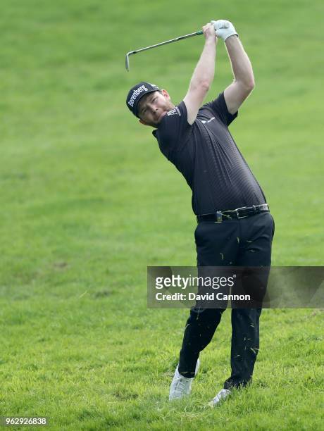 Branden Grace of South Africa plays his second shot on the par 4, first hole during the final round of the 2018 BMW PGA Championship on the West...