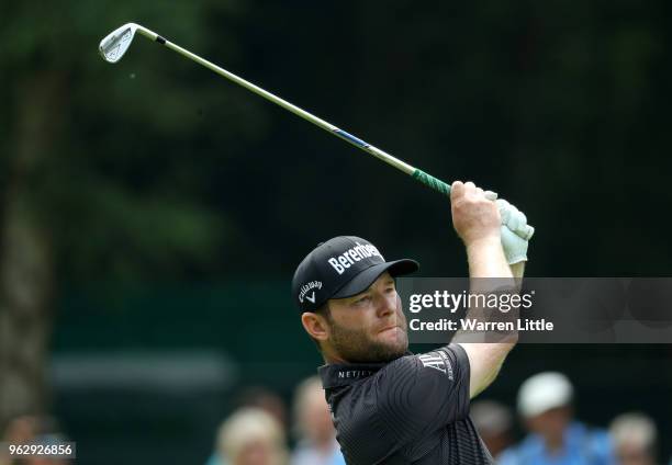 Branden Grace of South Africa plays his second shot on the 6th hole during day four and the final round of the BMW PGA Championship at Wentworth on...