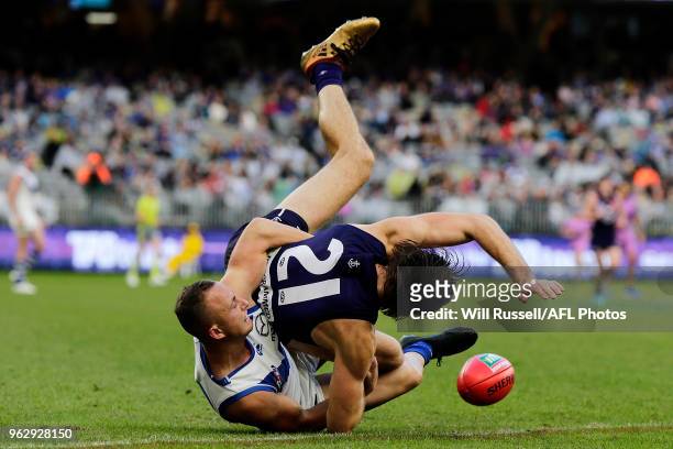 Joel Hamling of the Dockers is tackled by Billy Hartung of the Kangaroos during the round 10 AFL match between the Fremantle Dockers and the North...