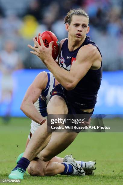 Nat Fyfe of the Dockers is tackled during the round 10 AFL match between the Fremantle Dockers and the North Melbourne Kangaroos at Optus Stadium on...