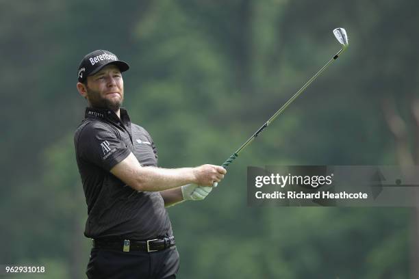 Branden Grace of South Africa hits his second shot on the 9th hole during the final round of the BMW PGA Championship at Wentworth on May 27, 2018 in...